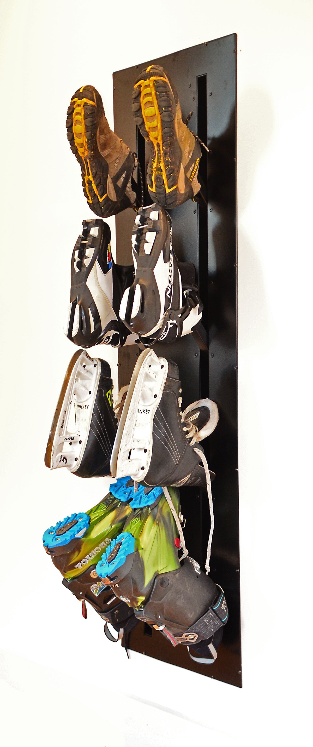 Ski boot dryer mounted in a wall and loaded with ski boots and skates.  For instalation in ski chalet or any mudroom. 